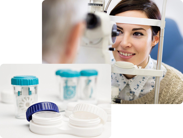 A woman sitting in front of an eye exam and two containers of contact lenses.