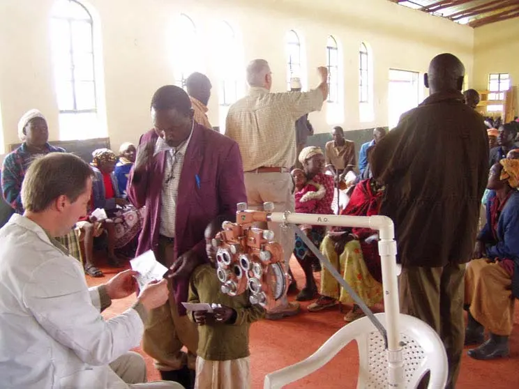 Dr. Rousselo volunteering in kenya giving prescription