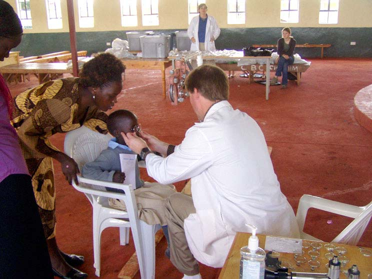 A doctor is examining a child in africa.