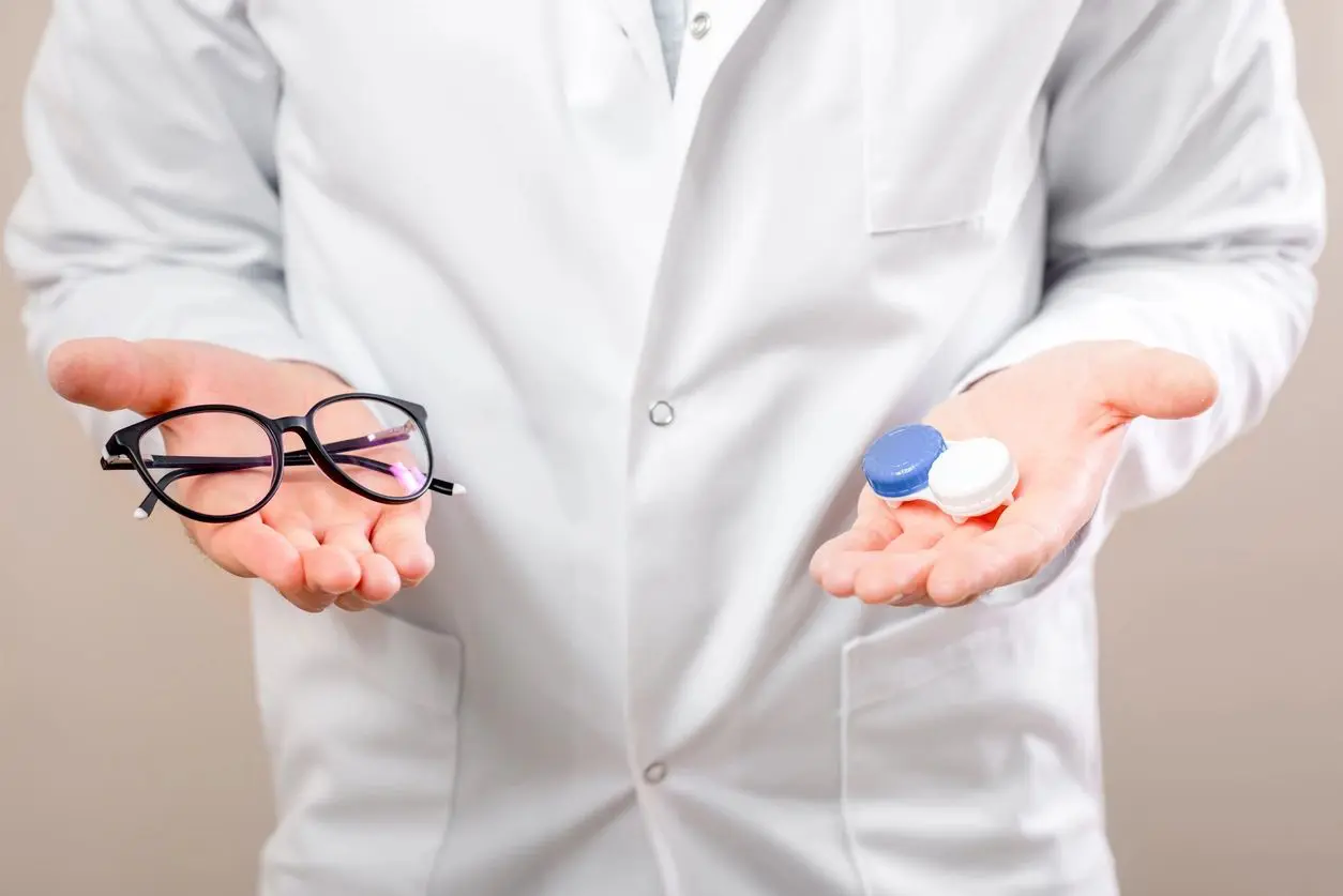 A person holding two different types of pills.