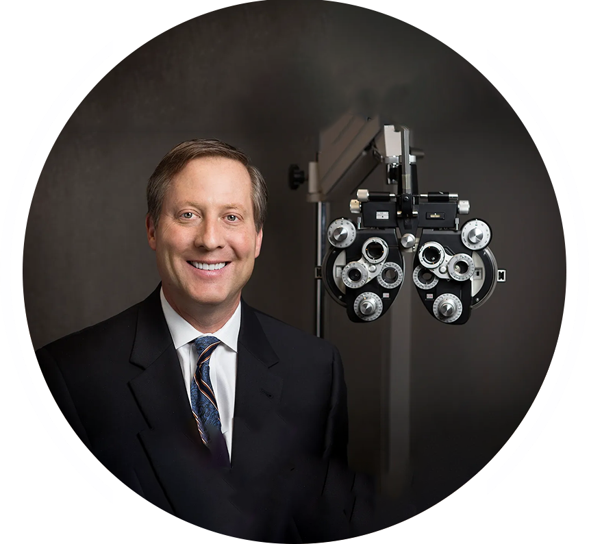 A man in suit and tie standing next to an eye exam machine.